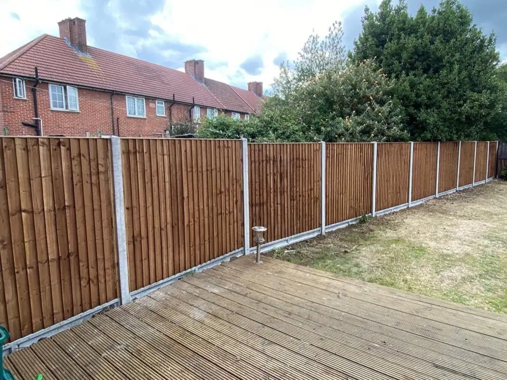 The same boundary after TBL Fencing Services replaced it — new closeboard fencing on concrete posts with gravel boards