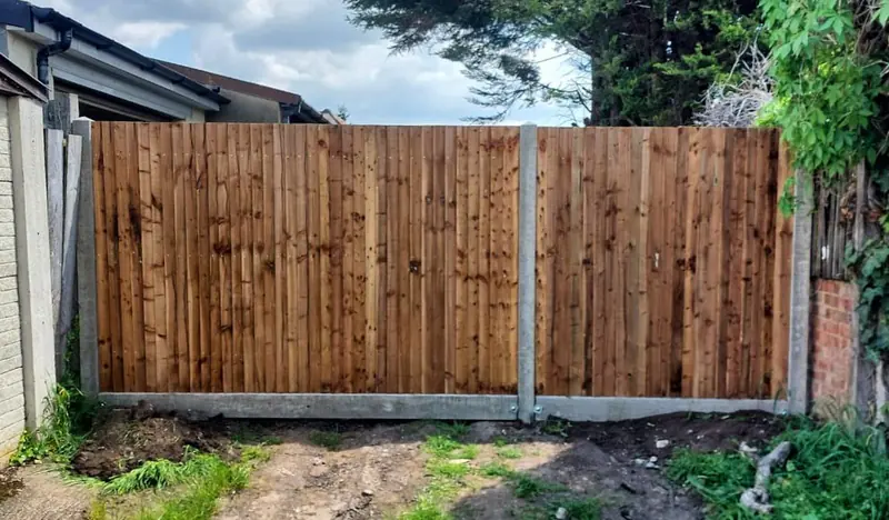 A replacement closeboard fence run on concrete posts with gravel boards