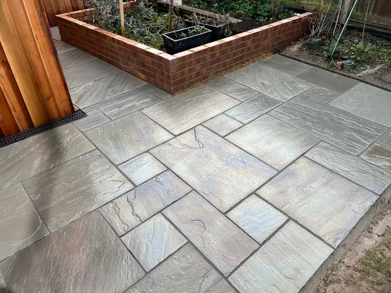 Indian stone patio with raised brick beds